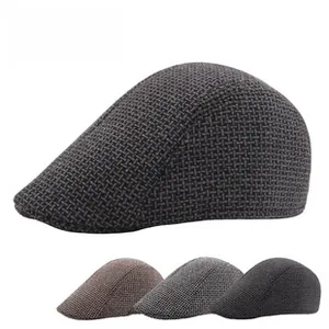 Detail view of knitted beret hats showing textured fabric in grey and brown colors