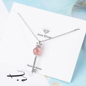 Elegant silver crown key necklace with pink strawberry crystal pendant on display card