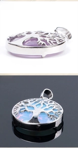 Detail of tree of life pendants in amethyst and opal stone with silver hollow metal frames