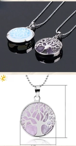 Detailed view of 38mm tree of life pendants with natural amethyst and moonstone inlay