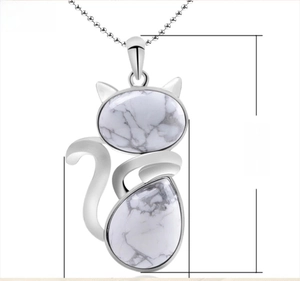 Detail view of a 50mm silver cat pendant with white marble stone on a thin bead chain