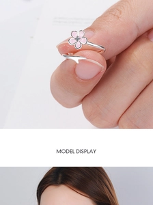 Detailed close-up of a silver adjustable ring featuring a pink enamel cherry blossom petal