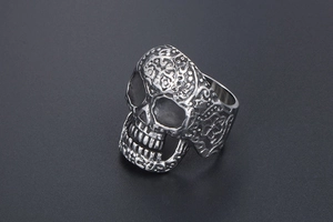 Detailed view of vintage silver skull ring with intricate gothic relief textures