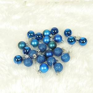 Blue Christmas ball ornaments in glossy, matte, and glitter finishes on white plush