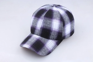 Close-up detail of the purple and black plaid pattern on a cotton baseball cap