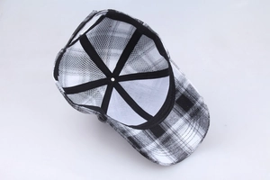 Interior detail of black and white checkered baseball cap showing stitching and mesh