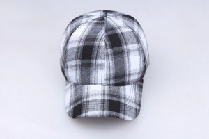 Detail view of the black and white plaid pattern and stitching on a cotton baseball cap