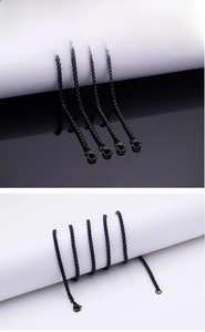 Macro shot of polished black stainless steel box chain necklace with lobster clasp