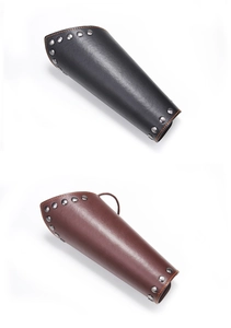 Detail view of leather punk wrist guards with rivets and orange stitching in black and brown