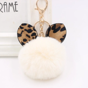 Creamy white plush pompom keychain with leopard print ears and a golden ring holder