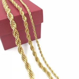 Three gold-plated stainless steel twist rope necklaces in various widths on a red gift box