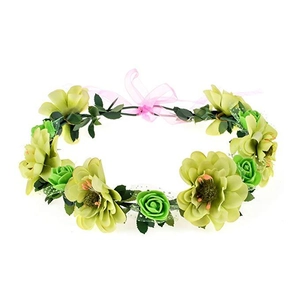 Close-up of green artificial flower crown with realistic leaves and pink ribbon tie