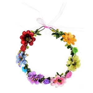 Close-up of vibrant floral bridal crown with multi-colored faux flowers and pink ribbon