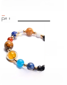 Detail of handmade Solar System bracelet with blue goldstone and planet natural beads