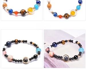 Detail of solar system planet bead bracelet with agate and natural stones on white background