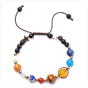Close-up of solar system eight planets bracelet with natural stones and gold star charm