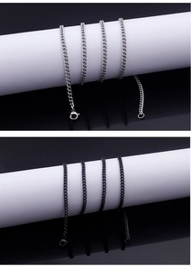 Detailed view of silver and black stainless steel extender chains with lobster clasps