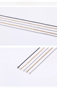 Detail of O-shaped chain connectors in black, gold, and silver stainless steel