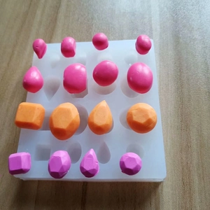 Detail of 16-cavity white silicone mold with geometric shapes for DIY resin crafts