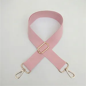 Close-up of pink adjustable nylon bag strap with high-quality gold metal swivel hooks