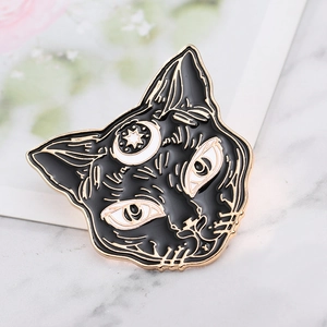 Punk style black cat head brooch with gold crescent and stars on white marble