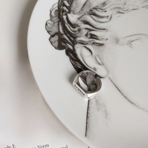 Macro shot of S925 sterling silver wide ring with breeze engraving on art plate