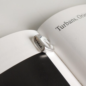 Macro view of matte S925 sterling silver ring with breeze engraving and purity stamp