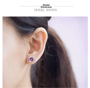 Close-up of heart-shaped purple amethyst stud earring with small diamond accents