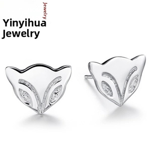 Detailed close-up of polished silver fox head stud earrings with sparkling crystals