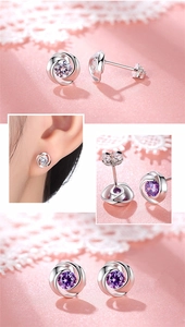 Macro view of S925 sterling silver flower earrings with purple and white zircon stones