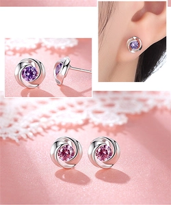 Detailed close-up and model view of silver flower stud earrings with purple crystals