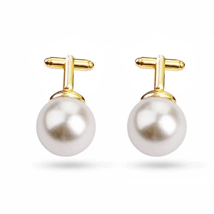 Macro detail of high-luster white pearls set on gold plated business shirt cufflinks