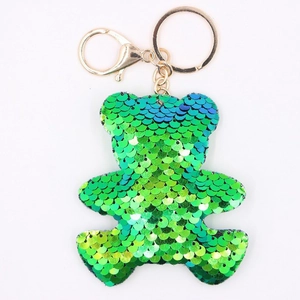 Sparkly green sequin bear keychain with gold metal lobster clasp on white background