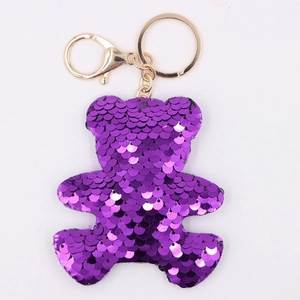 Close-up of purple sequined bear keychain with polished gold metal lobster clasp