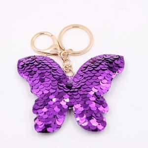 Reflective purple sequin butterfly keychain with a polished gold-tone metal ring