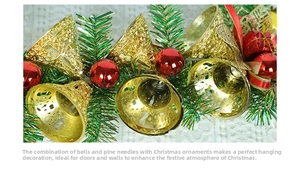 Close-up of Christmas ornaments with gold bells, red balls and green pine needles