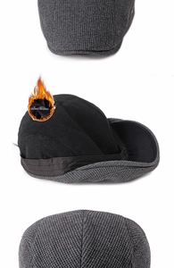 Detailed view of the warm fleece lining and knit texture of a grey men's beret flat cap