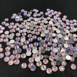Macro shot of iridescent lavender round flatback rhinestones for nail art on black background