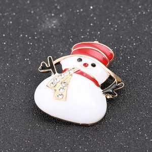 Detailed close-up of a Christmas snowman brooch with red enamel and sparkling rhinestones