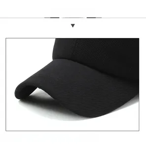 Detailed macro view of the black corduroy baseball cap's brim and sport embroidery