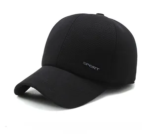Detail view of the SPORT embroidery on the side of a thick black corduroy winter baseball cap