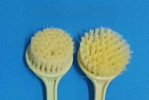Detail showing two types of cleaning brush bristles with wheat straw long handles