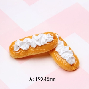 Macro detail of 19x45mm resin eclairs with white cream frosting for DIY crafts