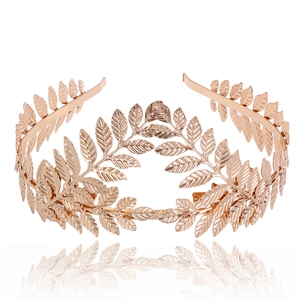 Macro shot of rose gold metal leaf bridal crown with detailed laurel leaf design