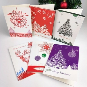 Detail of assorted Christmas greeting cards with reindeer and tree cutout designs