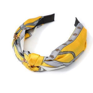 Knotted satin headband with gray chain patterns on yellow background for women