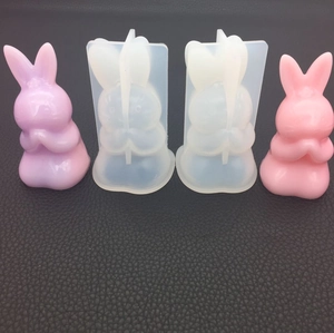 Detail view of rabbit silicone molds and resin cast figures in pink and purple colors