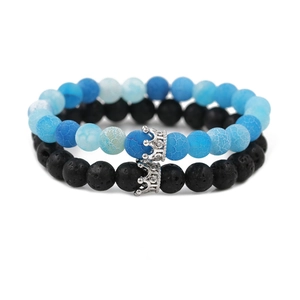 Macro view of blue weathered stone and black lava rock beaded bracelets with silver crowns