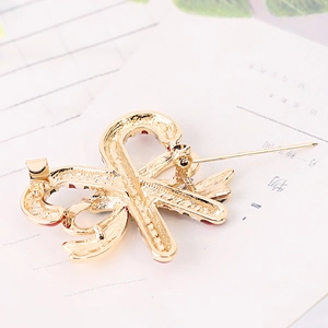 Detail of a golden bowknot brooch showing the secure metal pin back and smooth finish