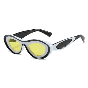 Retro cat-eye sunglasses with white and black contrast frames and yellow lenses